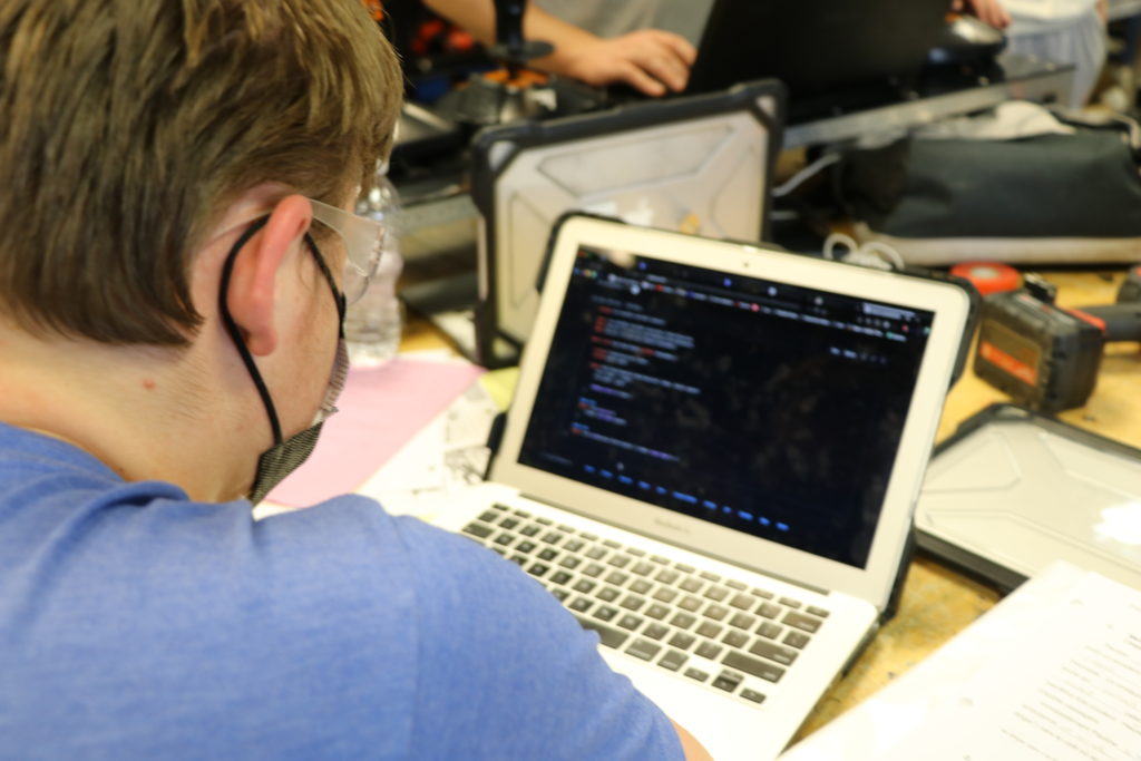 A student programming on their computer.