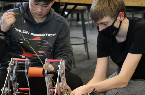 Two students working on the robot.