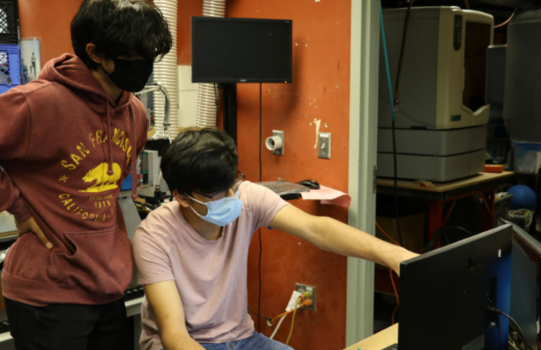 two students using the CAD computer.