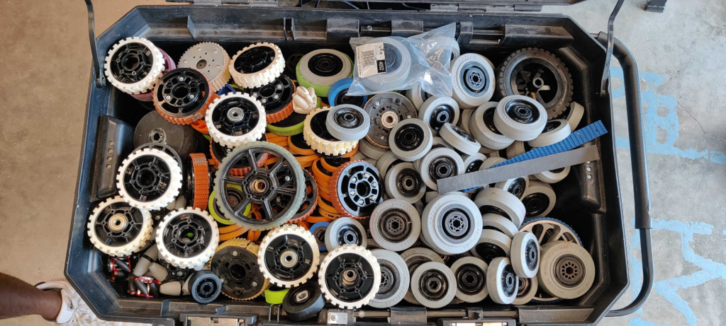 A massive crate with different types of wheels organized into piles.