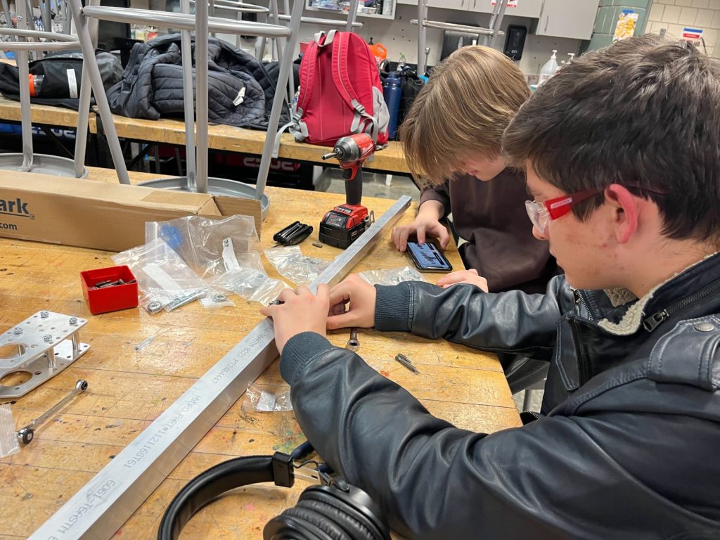 Two members working on machinery 