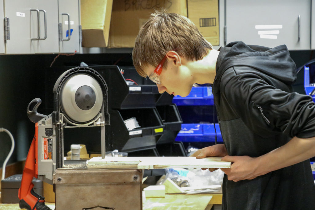 A student working on the vertical bandsaw