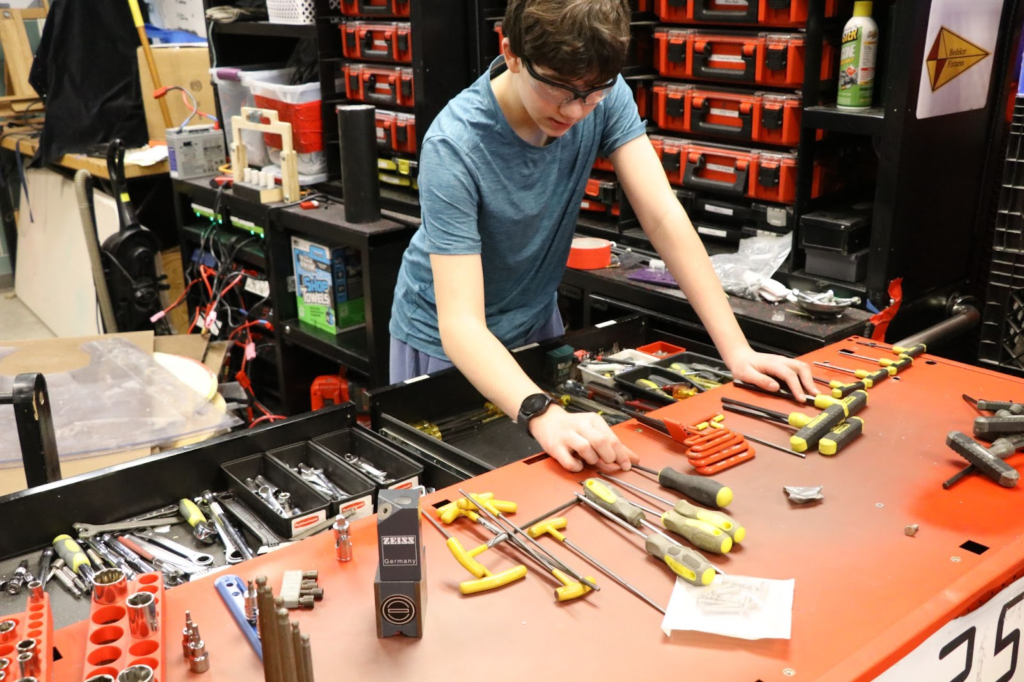 A student organizing the tool cart. 