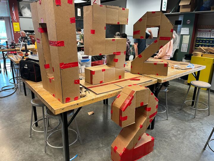 The numbers scrambled. all of which are three feet tall and made out of cardboard.