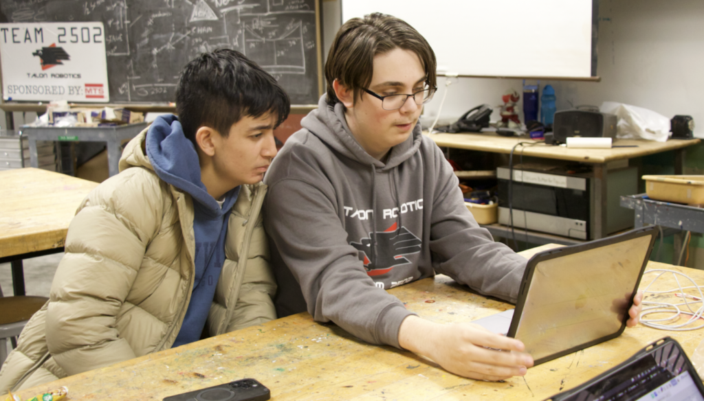 two members working on CAD on a laptop 