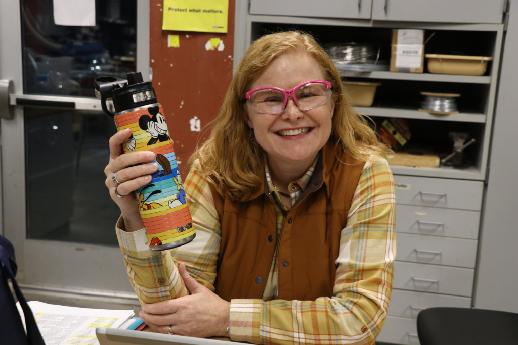 Sandy smiling holding a water bottle