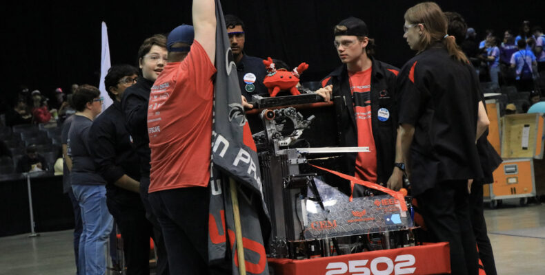 Our drive team loading the robot for a match