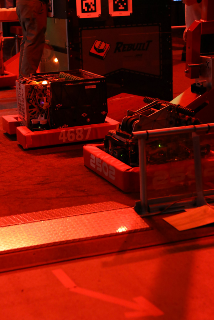 Our robot sitting on the field with dramatic red lighting