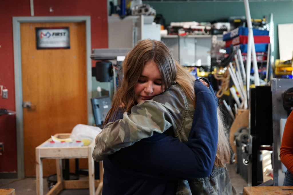 Ally and Charlotte hugging in room