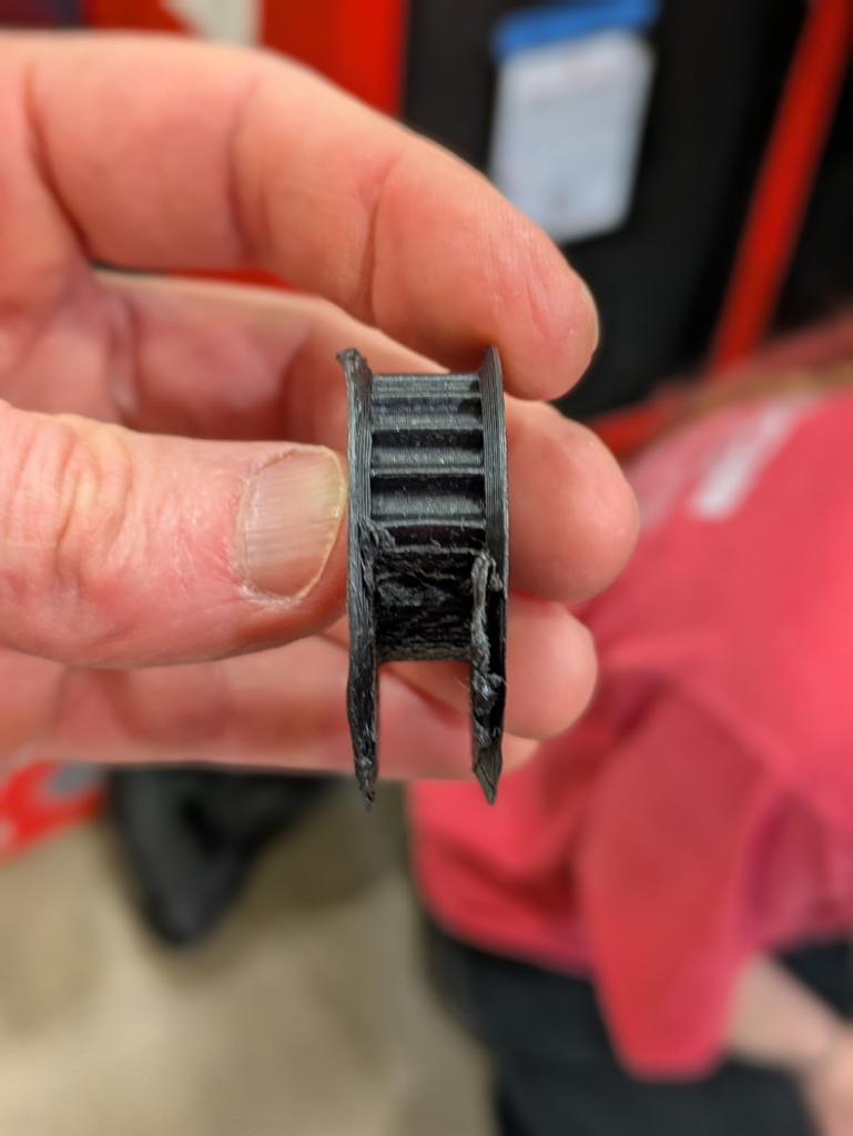 An absolutely destroyed pulley, it seems to be half melted