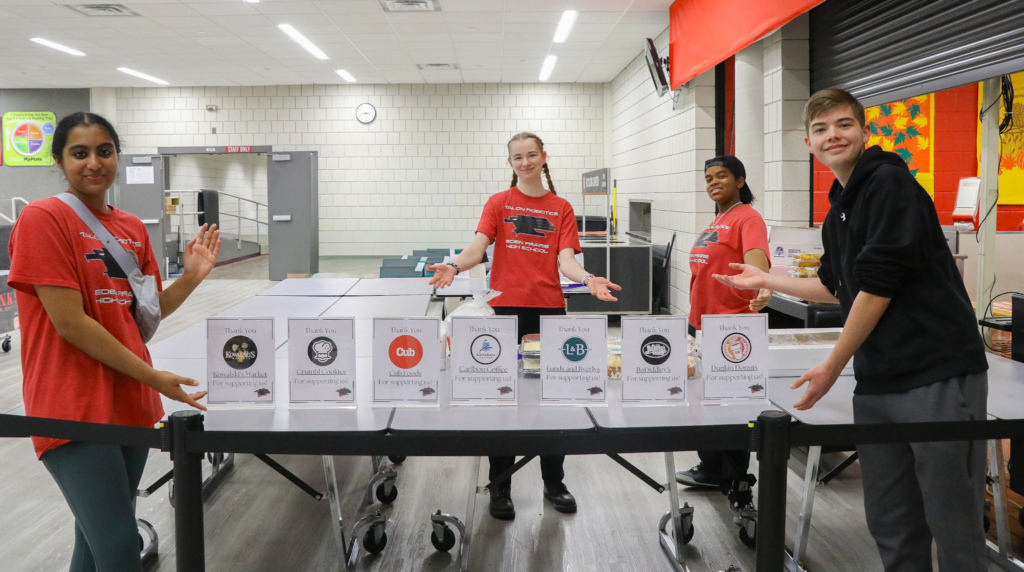 Team members showing off the 7 event sponsors for Robots and Rotini