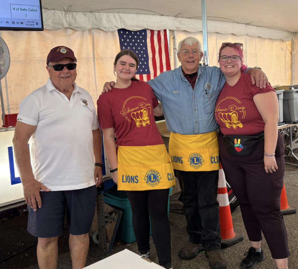 Charlotte and Ellie posing with Lions Club members