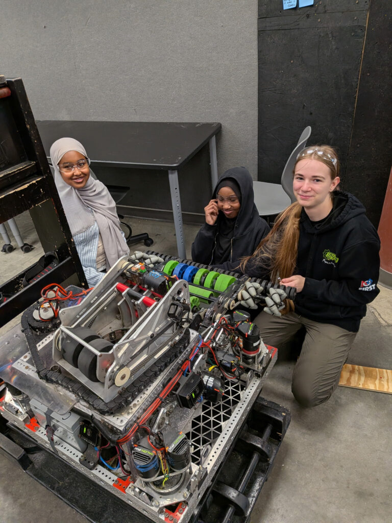 A captain and two new members working on robot